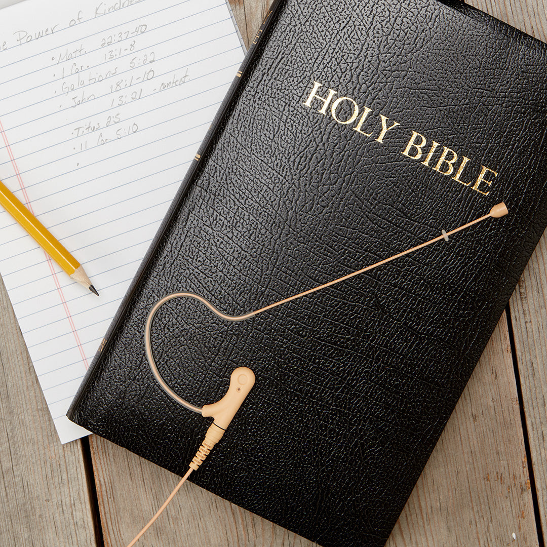 Single ear headset microphone suitable displayed on a bible